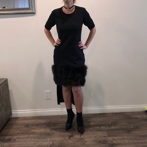 Black cocktail dress with uneven hem and fur trim